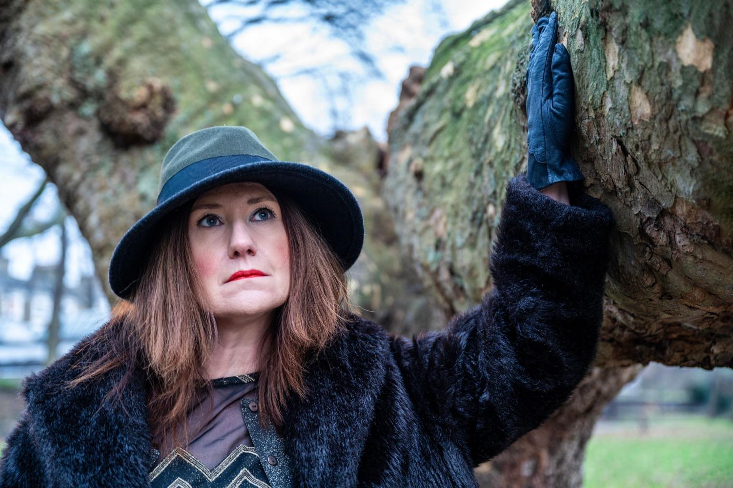 Alison Cotton wearing hat by a tree