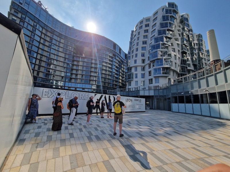 People standing in front of glass building