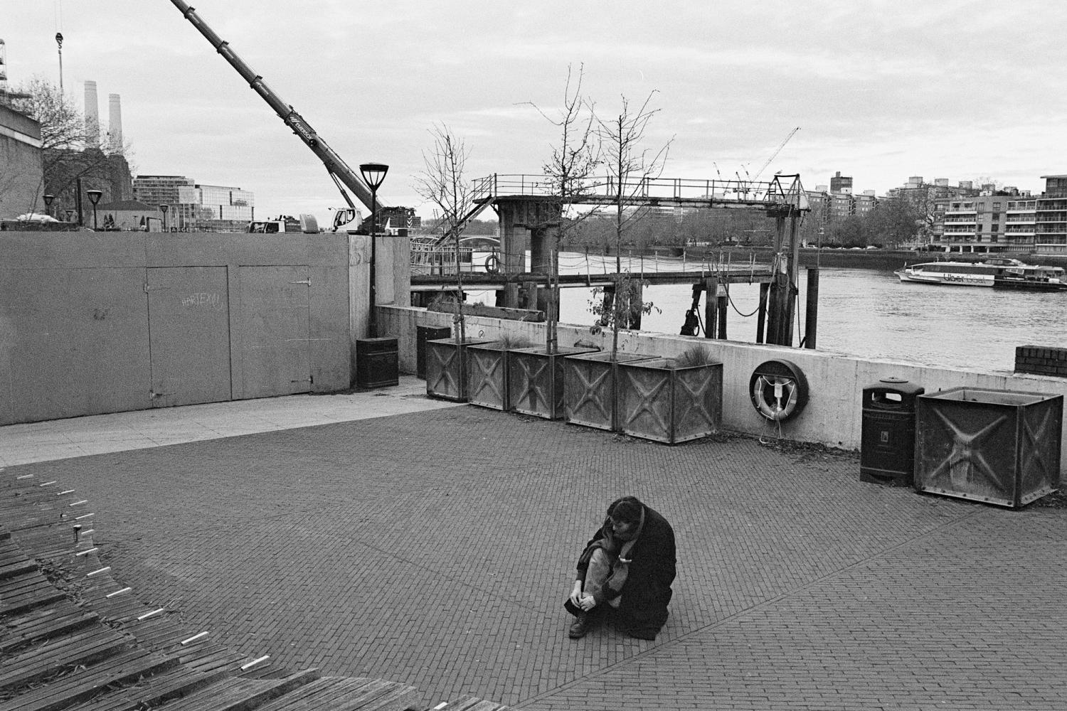 A photograph of the Thames Walk in Nine Elms. The performer is walking to trace a small square.